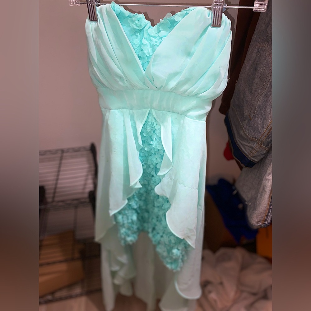 Teal prom dress with flower accents and flowy tail